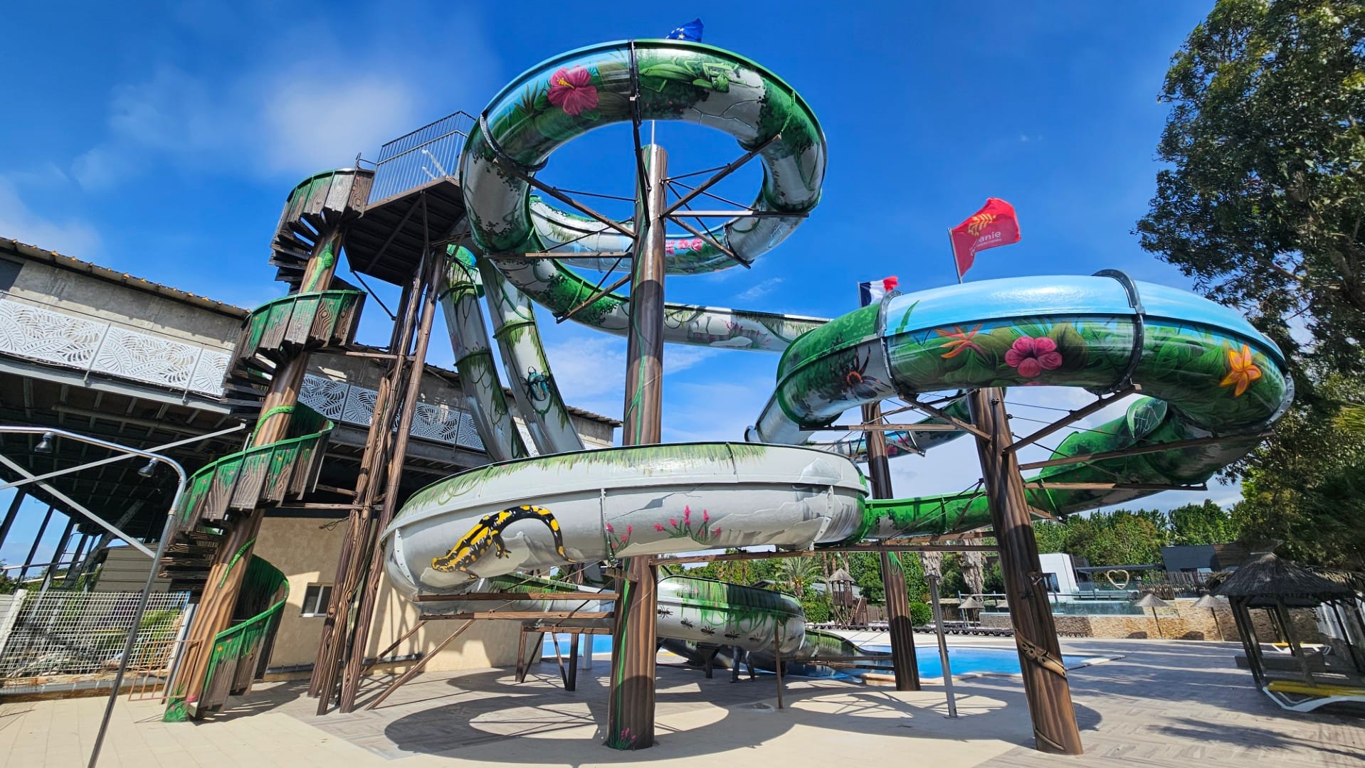 Après rénovation : toboggans du Camping Les Mimosas peints d'une végétation tropicale inspirée de Bali